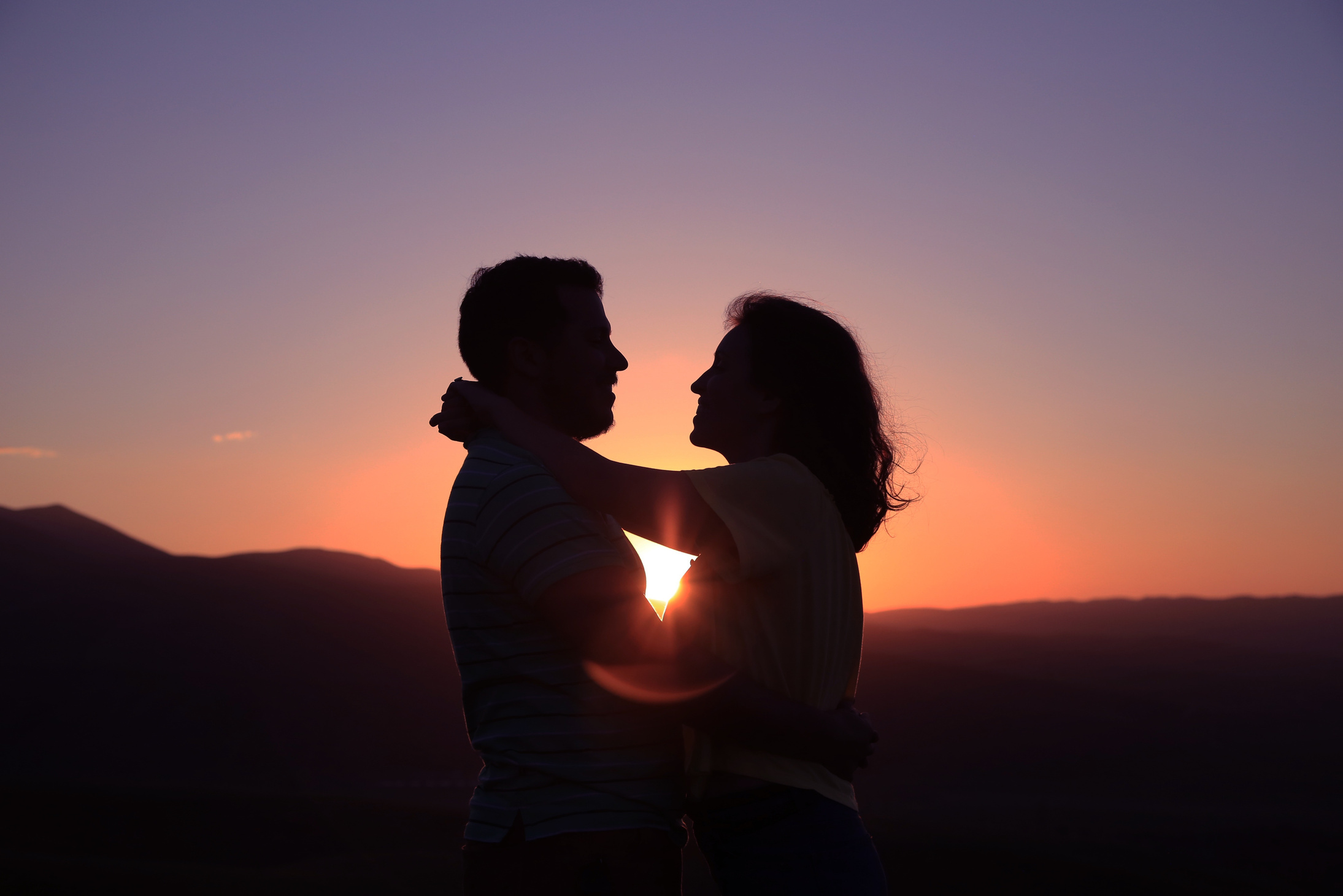 Couple Hugging Outdoors at Sunset